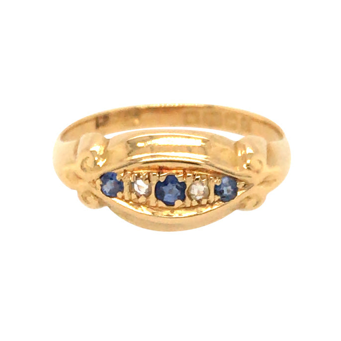 An 18ct yellow gold gypsy ring with three sapphires and two diamonds set in a gold band, dated 1904.
